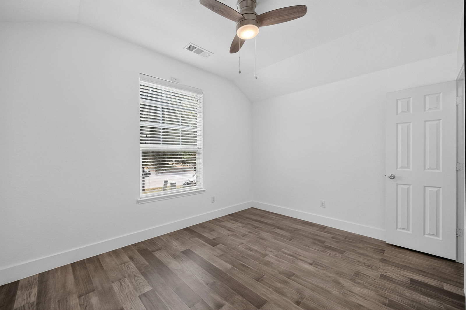 Secondary bedroom with vaulted ceiling
